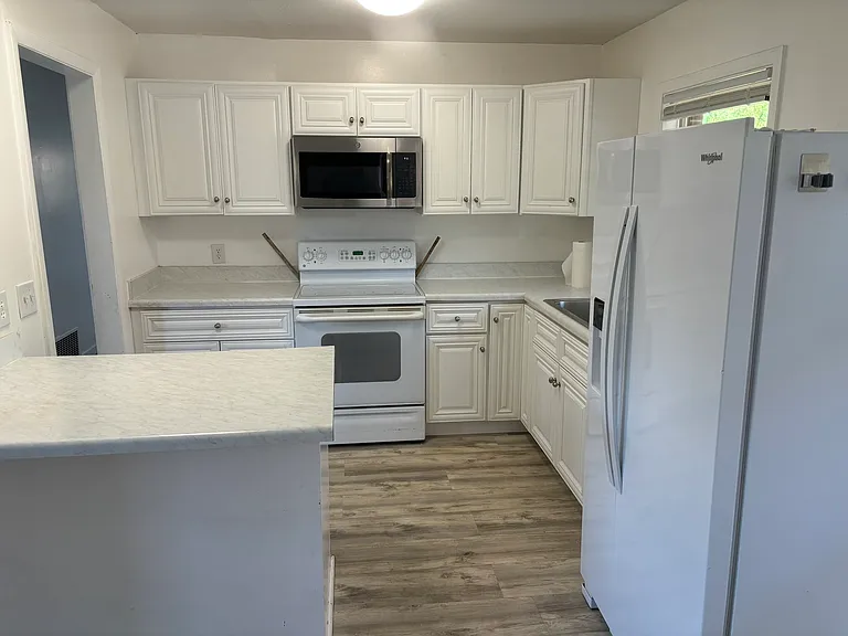 Bar area in the kitchen opens up to the breakfast area. Ample cabinet and counter space.
