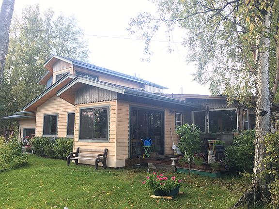 sunny yard and deck with view to kitchen and dining