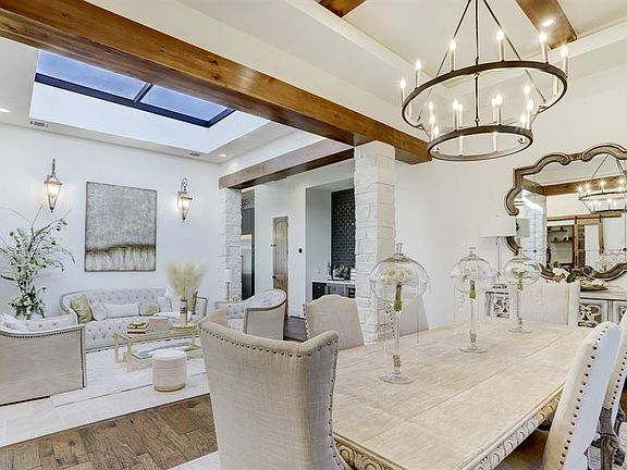 From the dining room, the sunken living room is bathed in natural light with the above sky roof.