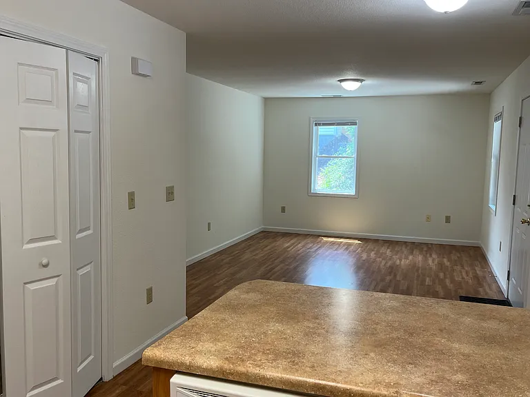 "Long" living space with living room area view from kitchen