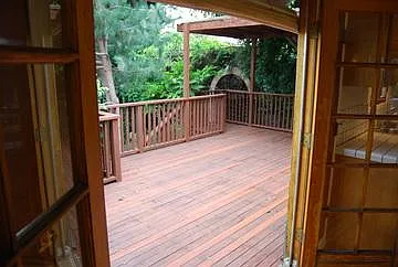 Thru French doors to large South facing deck and garden