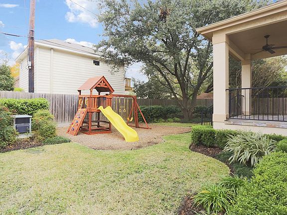 Note the covered back porch off breakfast room, perfect for outdoor grilling and entertaining w/ landscaped & sprinkled backyard.