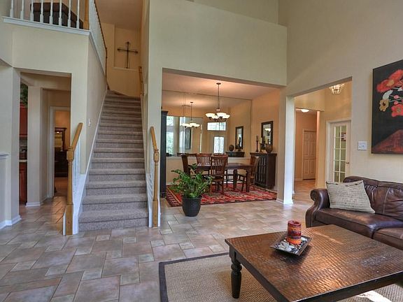 Formal dining area and stairs lead to the secondary bedrooms and bath.