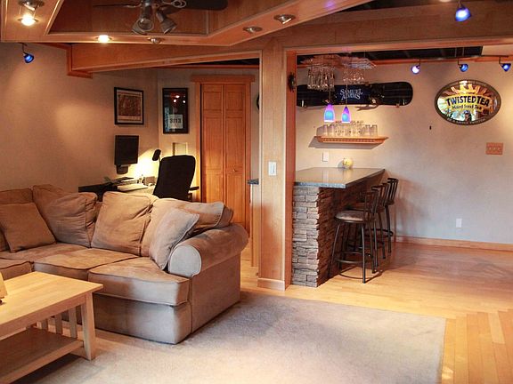 custome basement with hardwood and inset carpet