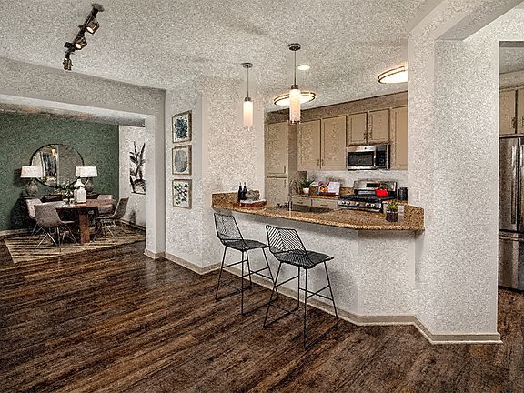 Kitchens with luxury vinyl plank flooring, gas ranges, shaker-style cabinets and stainless steel appliances