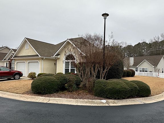 View from the street showing the corner lot location and attractive landscaping. This neighborhood is perfectly maintained by the HOA.
