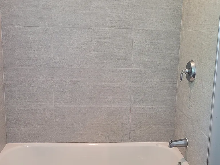 Primary bath with tub and beautiful tile surround