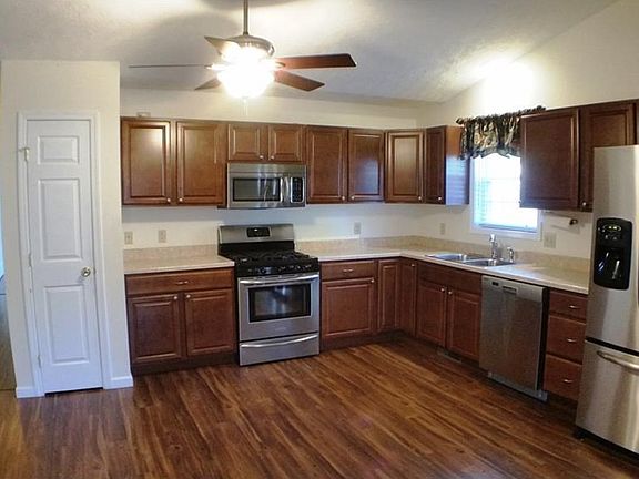 Awesome eat in kitchen with pantry, stainless appliances, vaulted ceiling and ceiling fan.