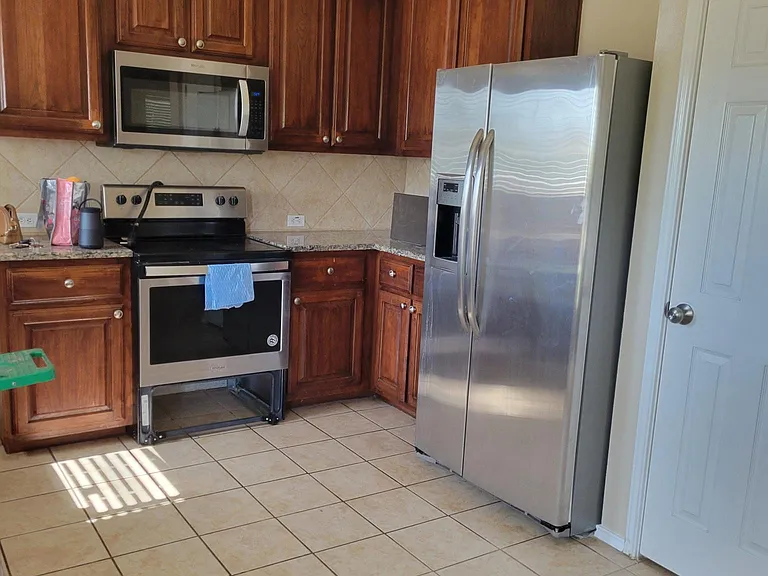 Kitchen (Refrigerator can stay if you need it). Tall Cabinets. Stainless steel and marble countertops.