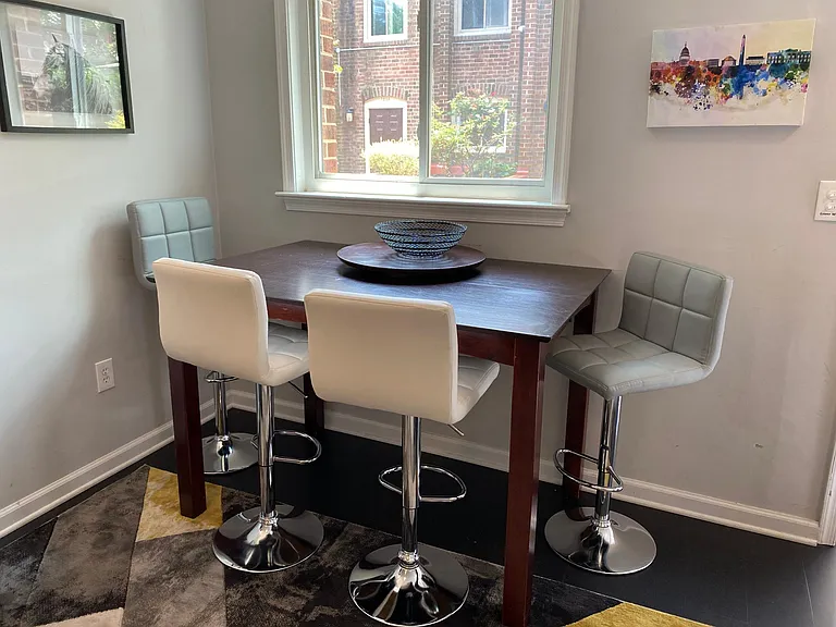 Dining table with seating for 4 and window facing patio at the entrance