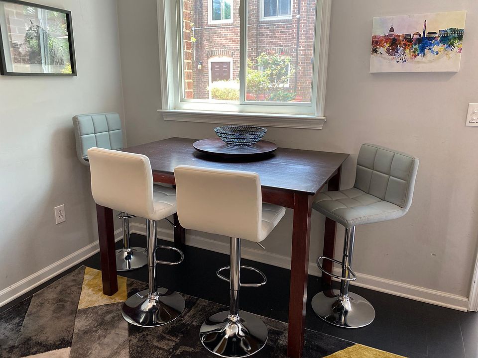 Dining table with seating for 4 and window facing patio at the entrance