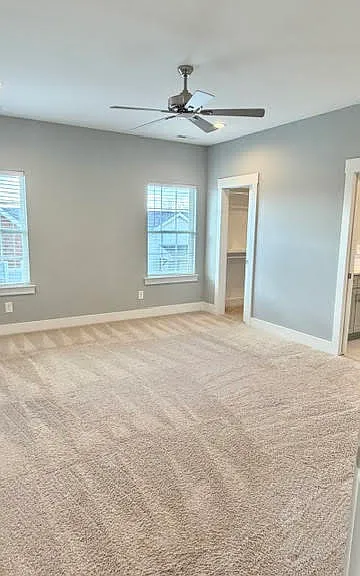 Primary bedroom with doors to walk-in closet and bathroom