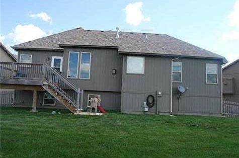 Back of home with very nice deck.