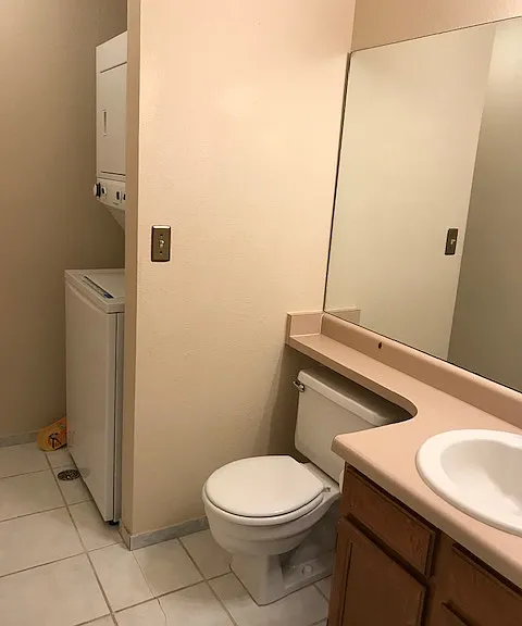 1/2 Bath main floor with large capacity laundry center (stacked washer/dryer)