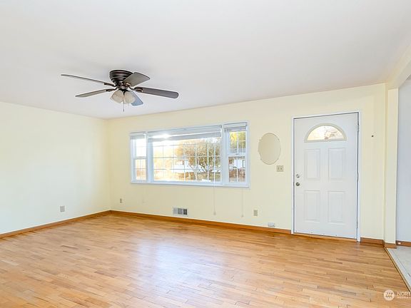 View from kitchen to back hall, garage door and stairs to your lower level.>