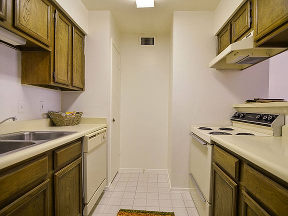 A kitchen with a double sink and a pantry
