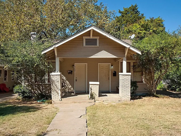 A cozy house with a charming front porch and a well-kept yard, creating a warm and inviting atmosphere.