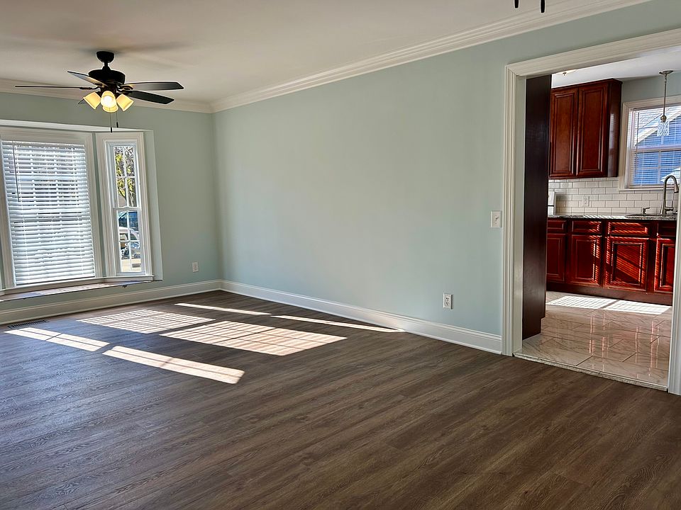 Living room looking toward front of house and kitchen