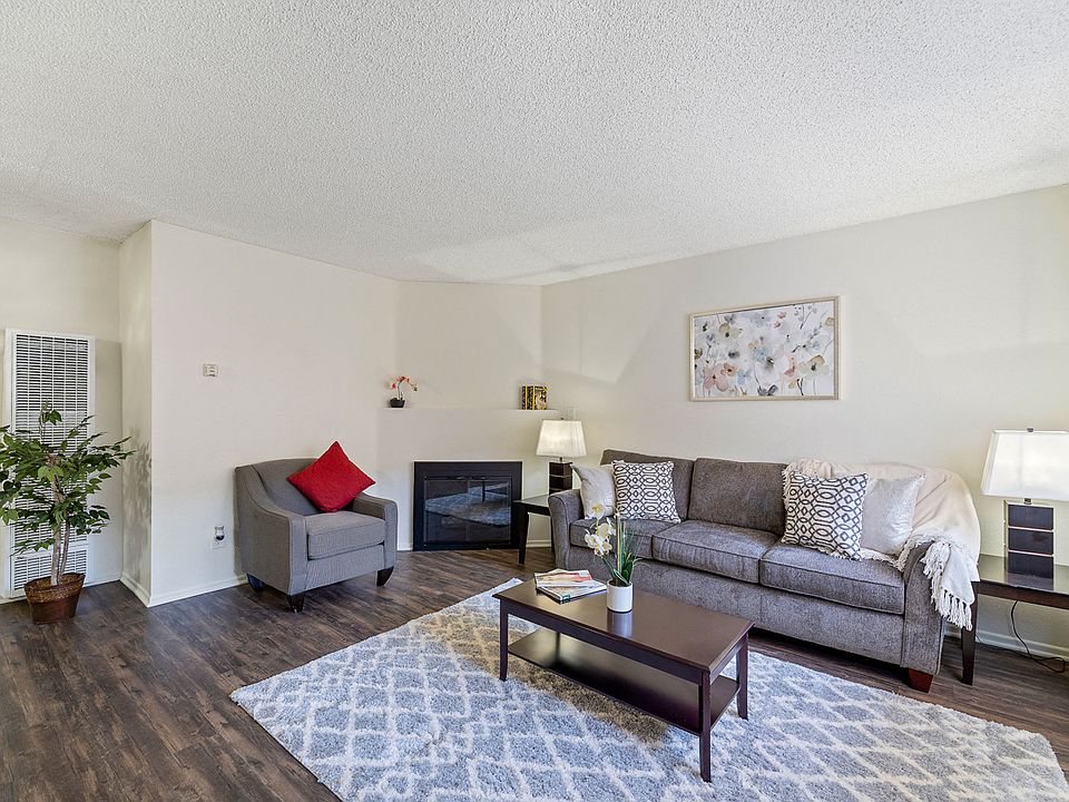 Spacious living room with a fireplace at the Enclave apartment in Studio City