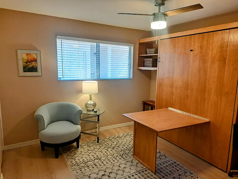 Den with desk attached to queen murphy bed