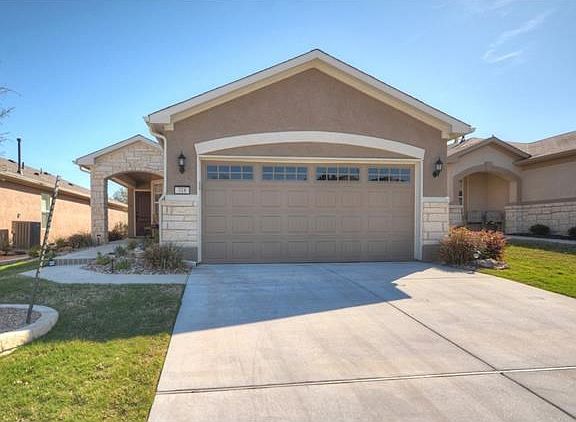 Pretty planting beds are ready for your seasonal color at this delightful Sun City Texas Gray Myst h