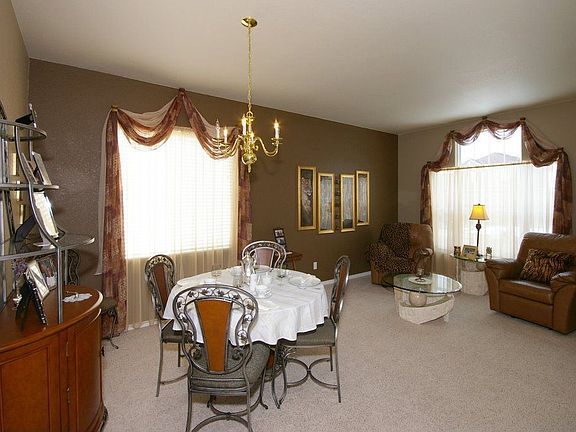 Another view of the carpeted living/dining room combination