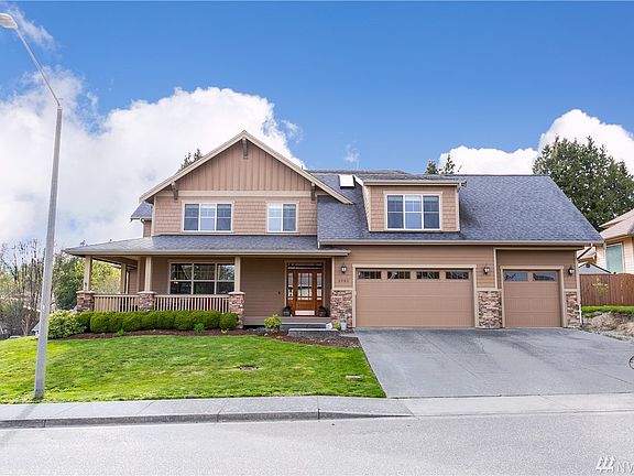 Elegant custom craftsman home. The exquisite details are apparent  as you approach. The oversized 3 car garage,  8 foot wide wraparound covered front porch, lush landscaping and it's impressive size will dazzle you when you first see this showcase home.