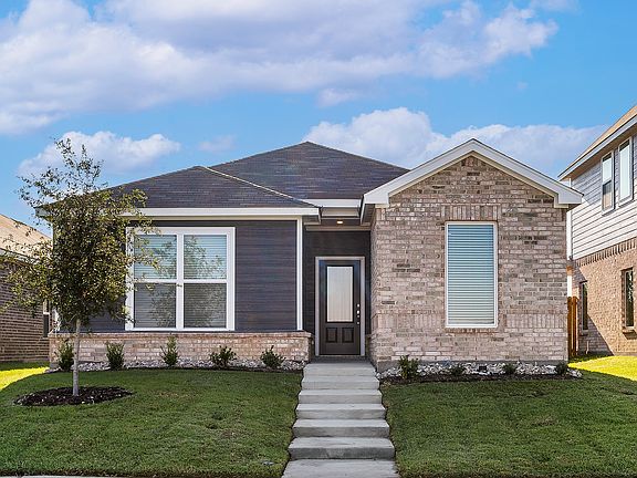 The Orchid is a beautiful one-story home with a siding exterior and brick accents.