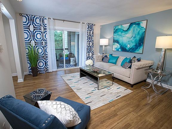 Your spacious living room features wood-style flooring and slider doors that lead to your very own private patio.