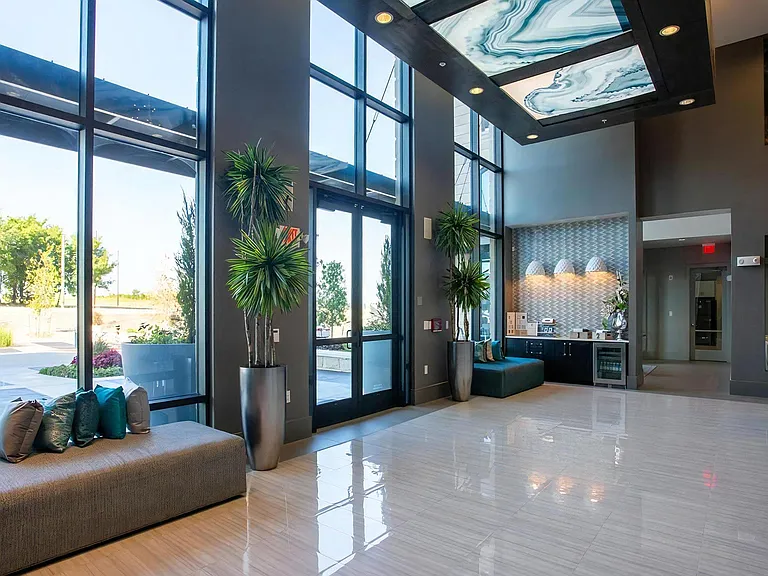Spacious Main Entryway Featuring Large Windows and Guest Seating Area
