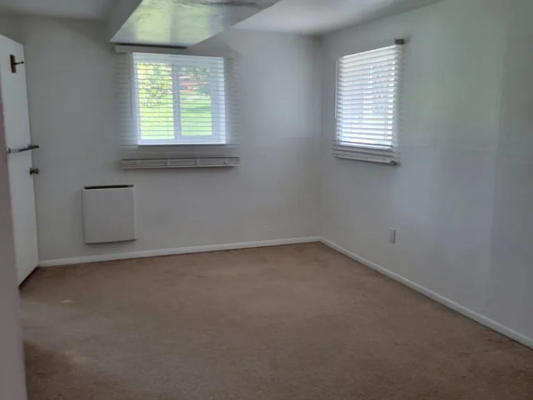 Downstairs primary bedroom with newly installed, high efficiency, cool touch heating unit. New carpet coming soon!