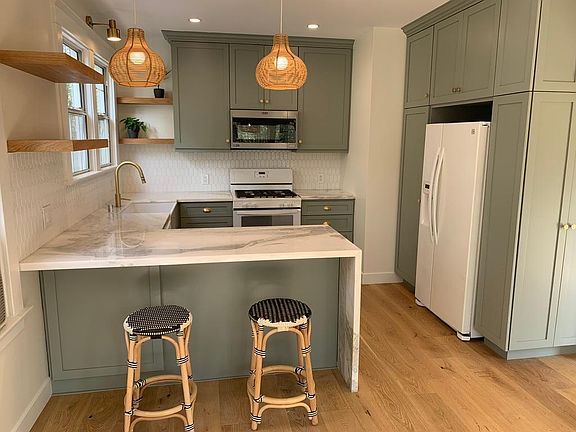 Modern custom kitchen with peninsula and counter for seating. Tons of kitchen storage
