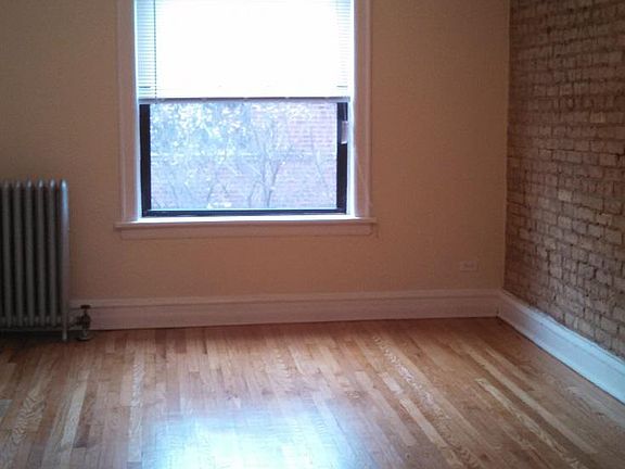 Living room with exposed brick and ceiling fan