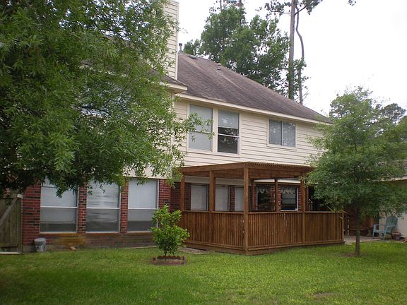 Back of house with covered deck 