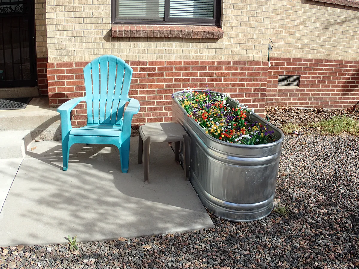 Newly added livestock flower garden and mini patio. - 1390 S Grant St