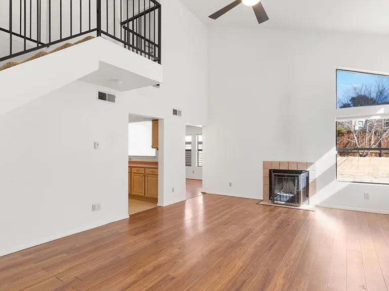 living room with stair view and kitchen is to the left