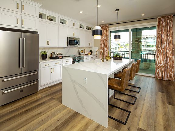 The central island offers a perfect spot for meal preparation and casual dining. It s a place where