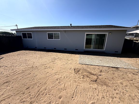 Fenced backyard with patio and sliding glass door