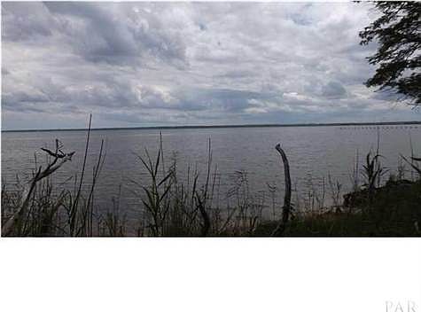 The waterfront lot affords wide open views ot the BAY