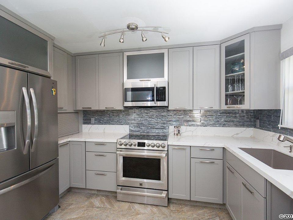 Kitchen with new stainless appliances, including dishwasher