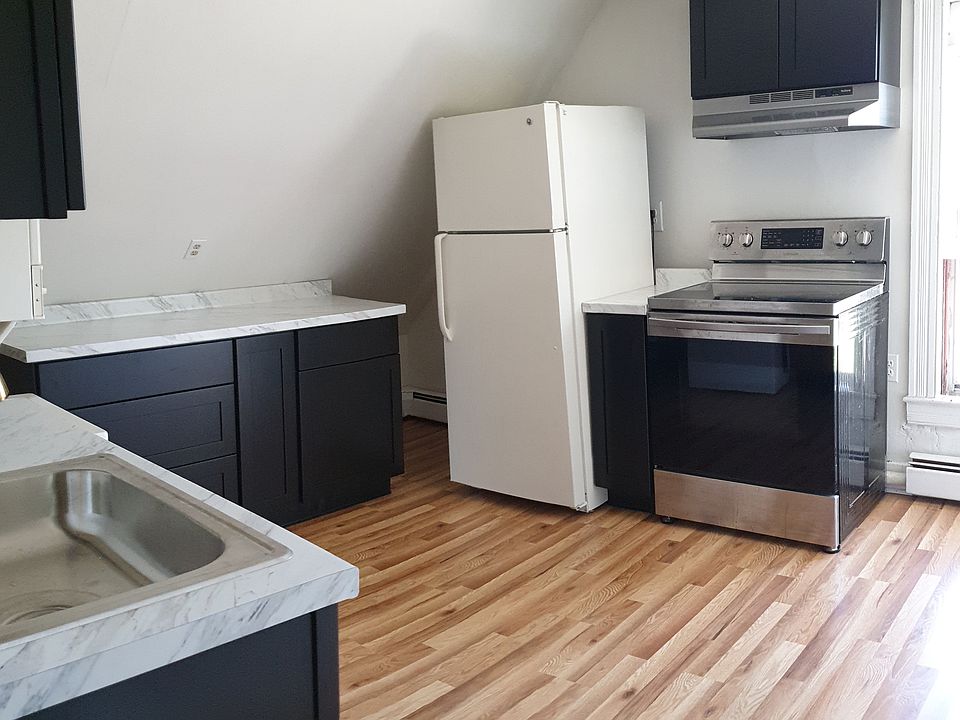 Bright and airy kitchen with ample cabinet space, pull out storage cabinets and modern upgrades