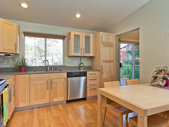 The wonderful, spacious kitchen was completely remodeled with Maple cabinets, silestone counters, bamboo floors and new appliances and has a window overlooking the garden above the sink.