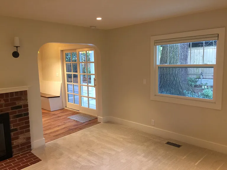 Living Room looking toward kitchen/dining and private backyard