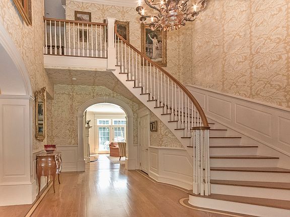 The elegant entrance hall foreshadows the stunning architectural details found throughout the home