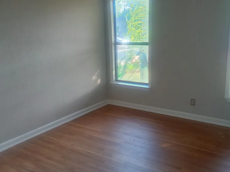 3rd bedroom completely remodeled with laminate flooring and ceiling fan.