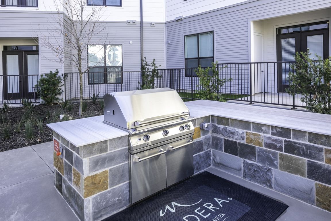 Indulge in outdoor living at its finest on Modera Walsh's lavish outdoor deck, featuring grills, an outdoor kitchen, and inviting al fresco dining areas for memorable gatherings under the open sky.