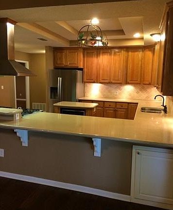 Kitchen is nicely updated with Silestone counters, stainless steel appliances, custom-built oak cabi