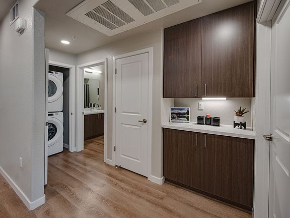hallway showing washer/dryer and storage