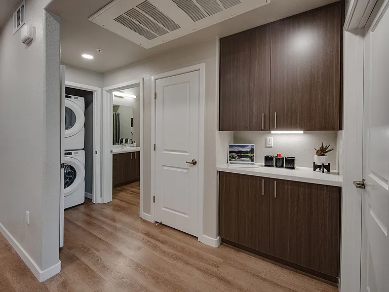 hallway showing washer/dryer and storage