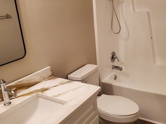 2nd bathroom shared between two bedrooms. New quartz countertops. Refurbished tub and shower.